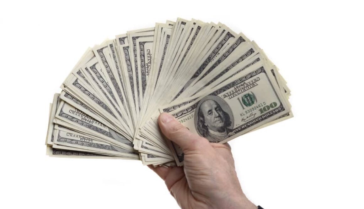 Man,Holding,Fanned,100,Dollar,Bills,Isolated,On,A,White